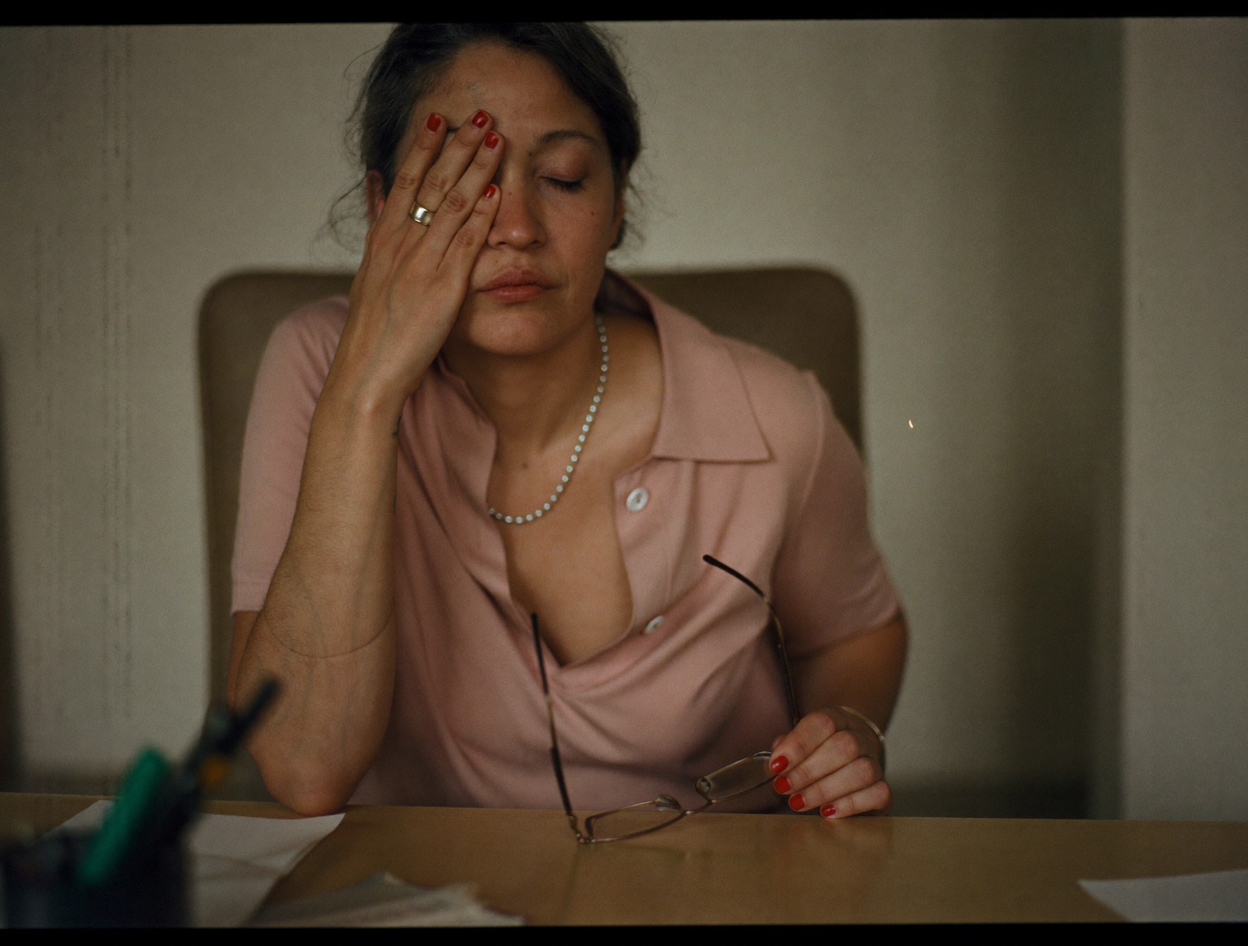 A woman pressing her tired eyes